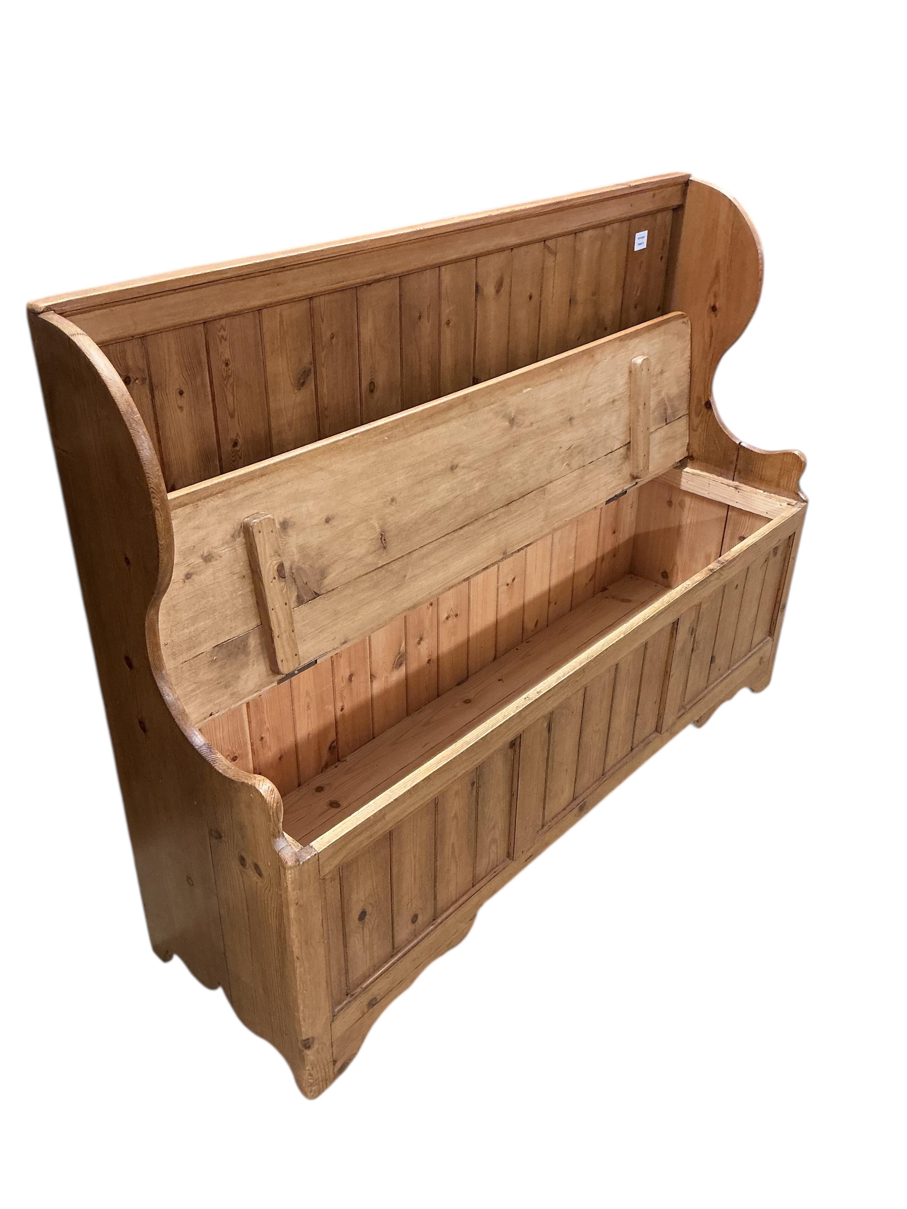 A Victorian style pine settle, with hinged box seat, width 135cm, depth 44cm, height 101cm